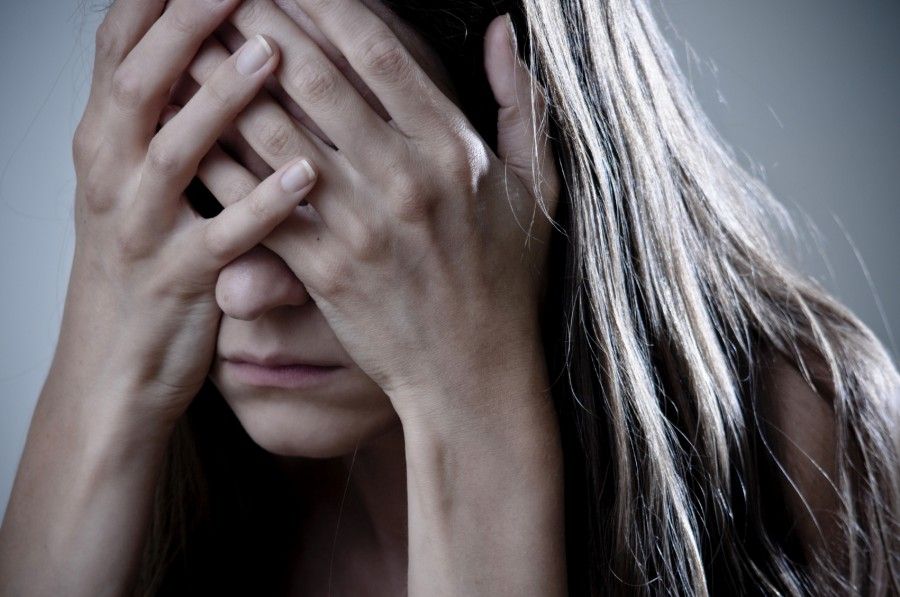 depressed woman with hands on the head