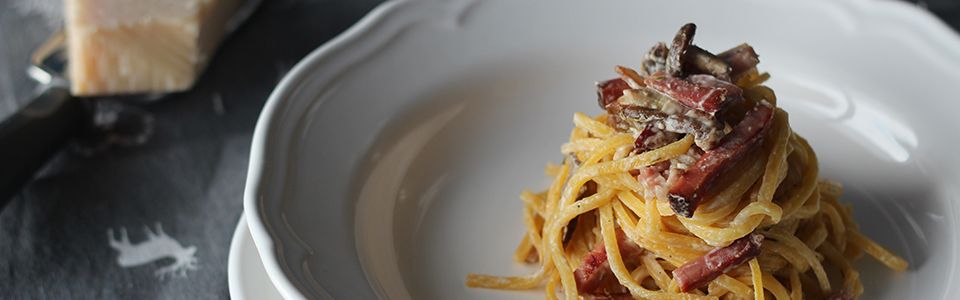 Spaghetti alla chitarra ai funghi, speck e crema alle erbe: ciao inverno