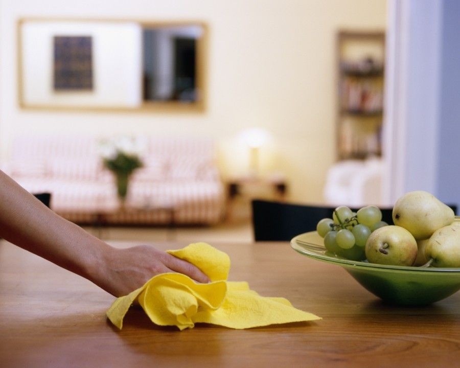 Female hand wiping dining table