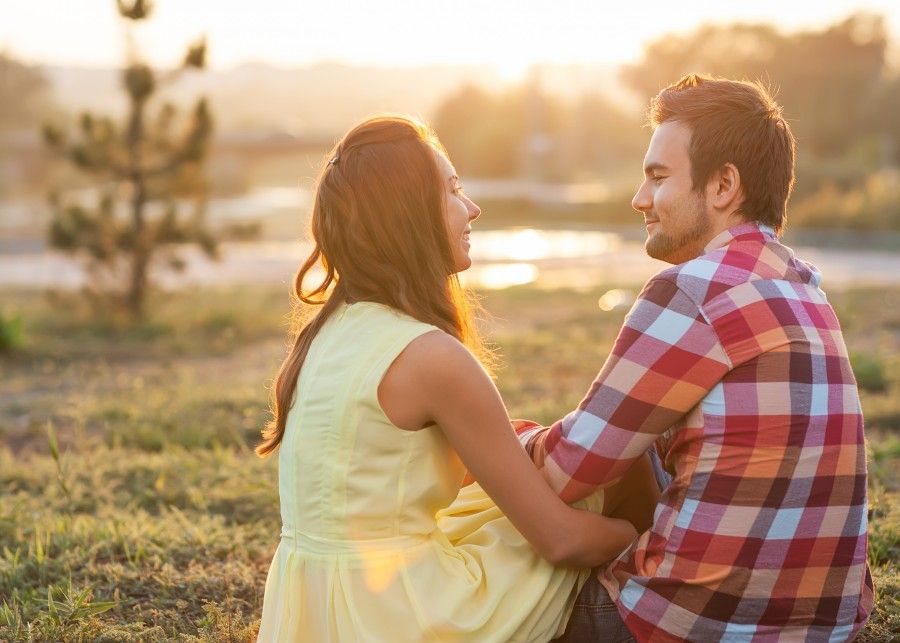 Young couple in love outdoor in the sunlight sunset.