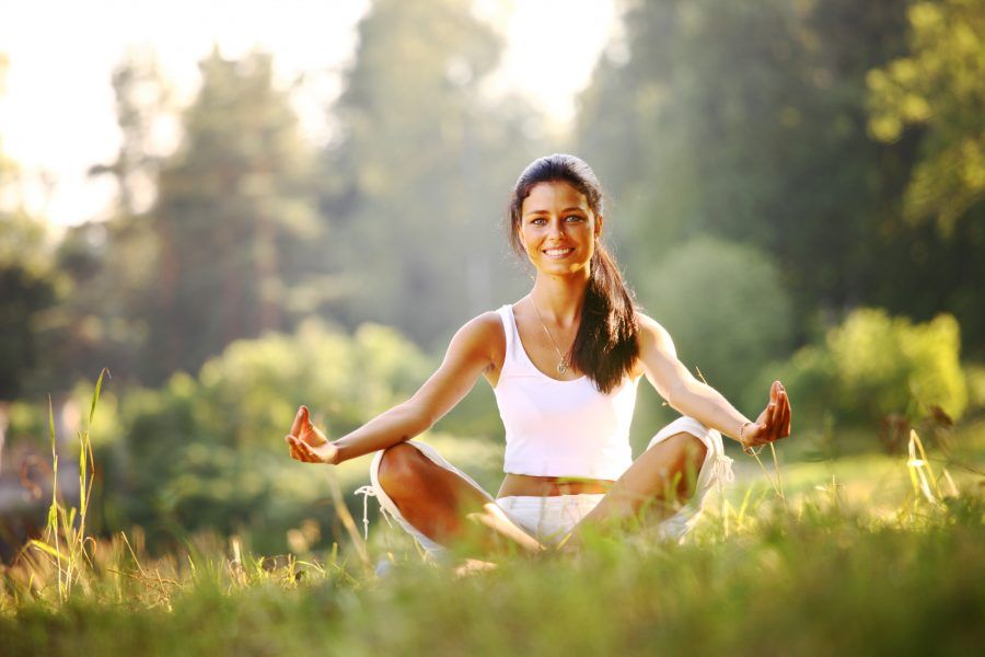 bigstock-yoga-woman-on-green-grass-12517412