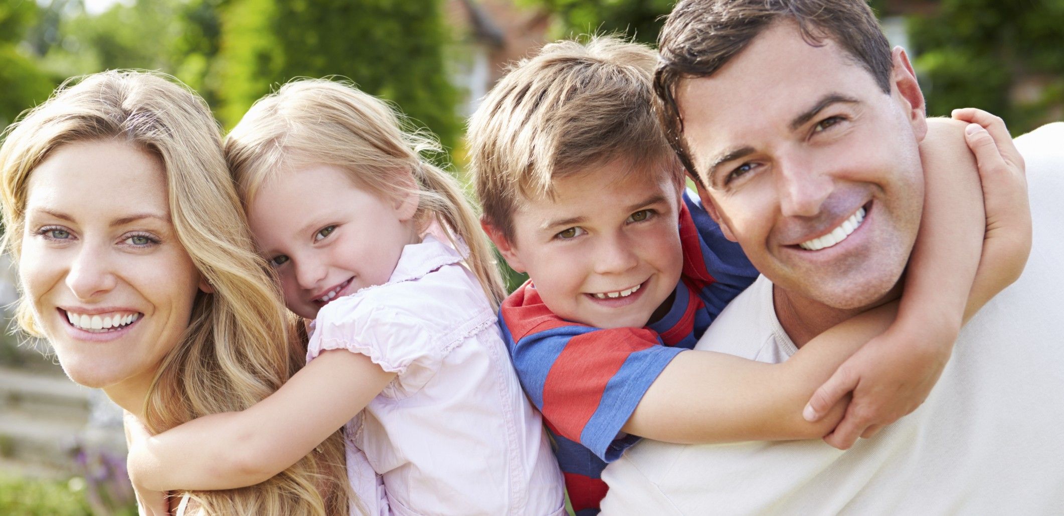 Portrait Of Happy Family In Garden