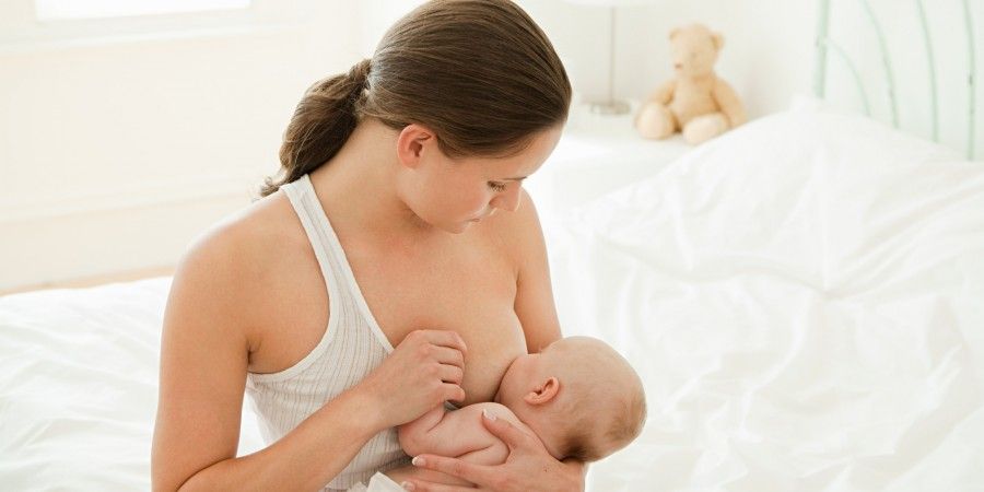 Mother breast feeding baby son