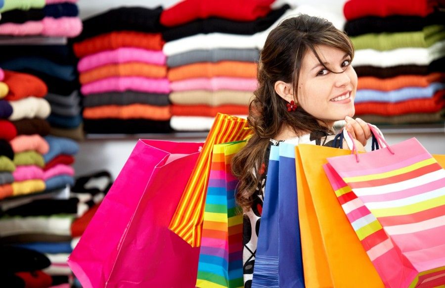 girl shopping and carrying bags in a retail store