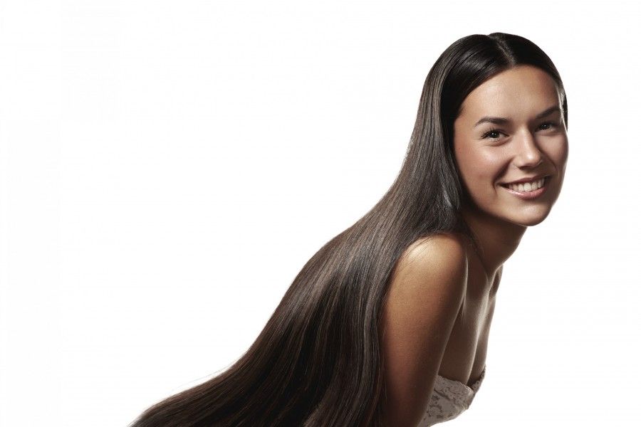 Woman with long straight strong hair --- Image by © pinkypills/Corbis