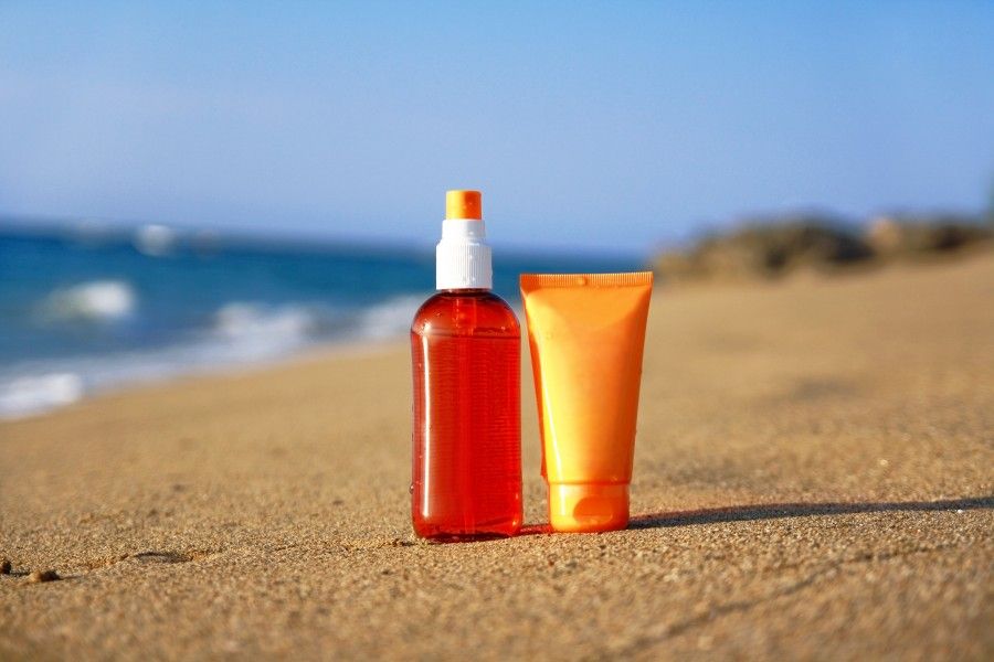 Tubes with sun protection on beach of Atlantic ocean