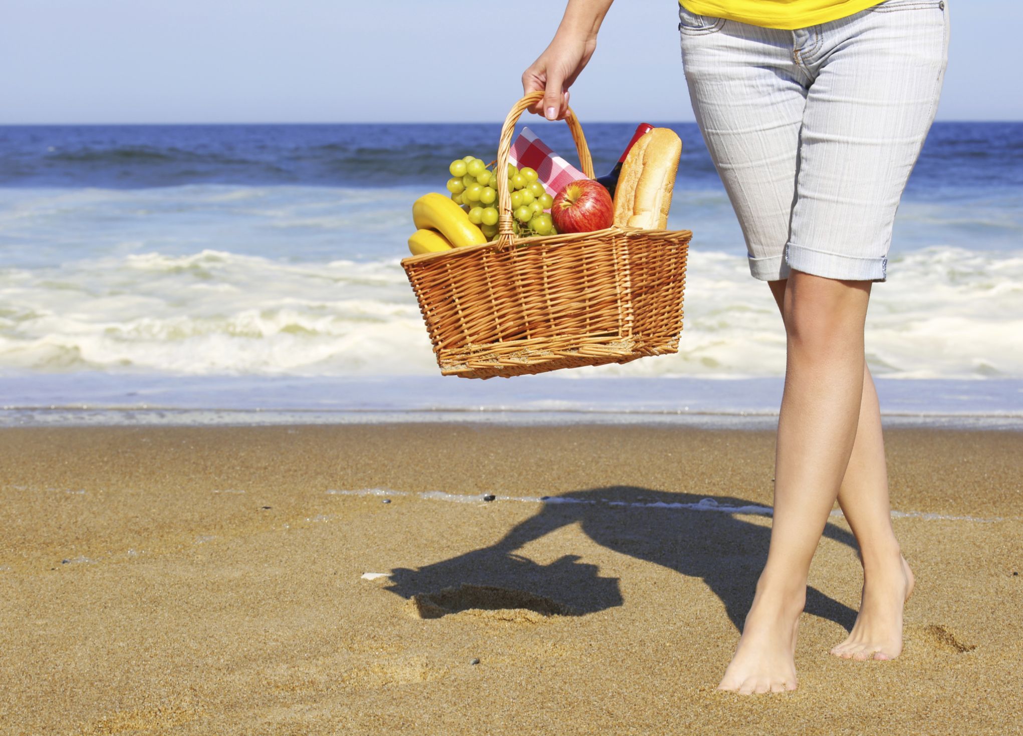 Picnic on the Beach. Female Legs and Basket with Food