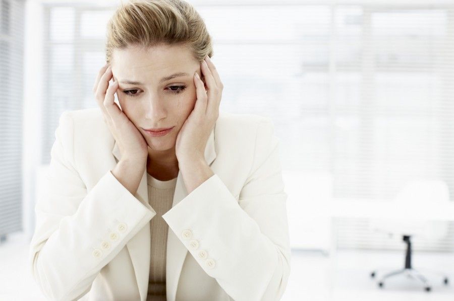 Businesswoman with head in hands