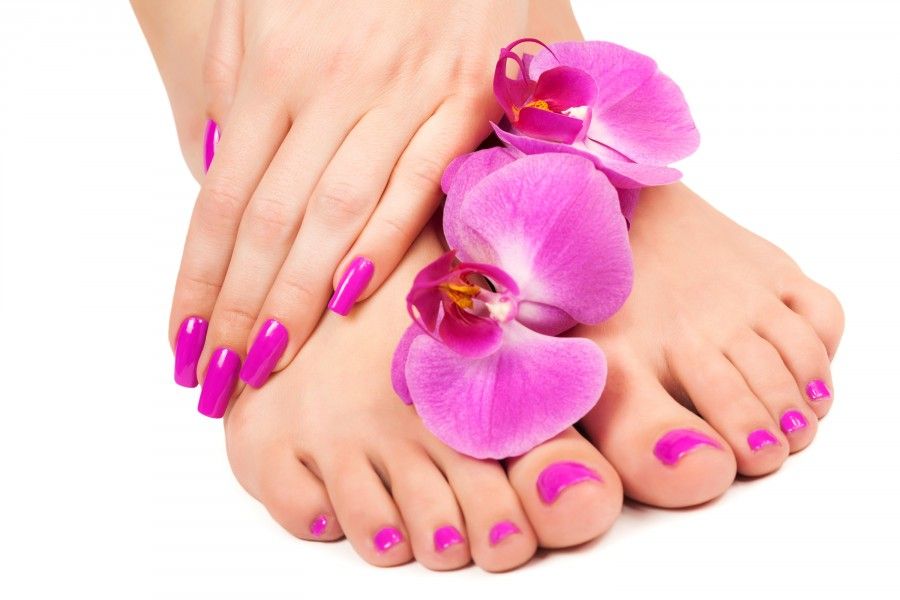 Relaxing pink manicure and pedicure with a orchid flower