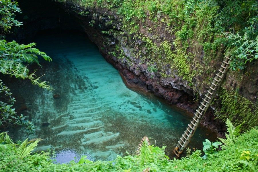 The "Toe Sua Ocean Trench".   There were only 3 things to see in Samoa - Lava Tubes, Beaches & Waterfalls. This was a lava tube. Jhei managed to get down that ladder without killing herself OR drowning. This compound was set in a really beautiful garden, as were a lot of places in Samoa