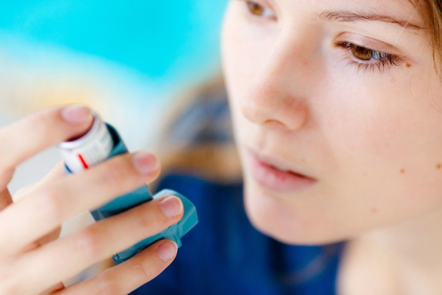 Mandatory Credit: Photo by Garo/Phanie / Rex Features (1492016ca) Model released - Woman using an aerosol inhaler that contains bronchodilator for the treatment of asthma. The inhaler dilates lungs airways to improve breathing. Various