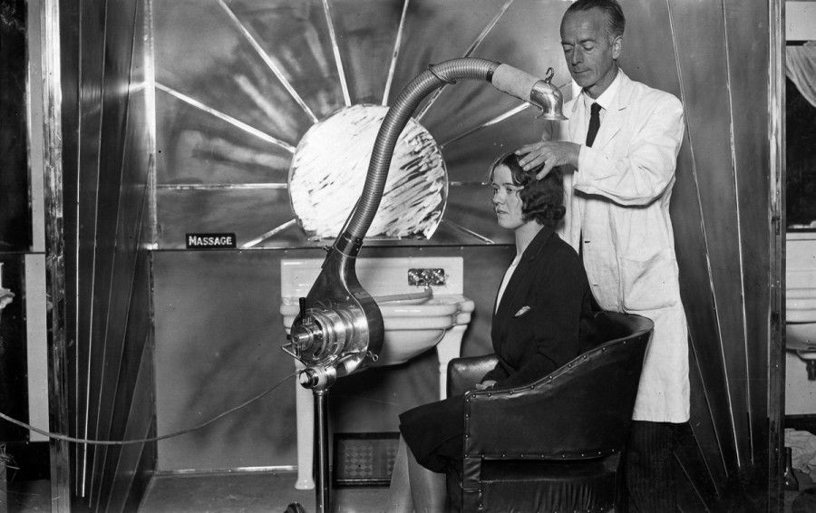 1929:  The new sunlight ultra-modern cubicle for hairdressing on show at the Hairdressing Fair of Fashion at London's White City.  (Photo by Puttnam /Topical Press Agency/Getty Images)