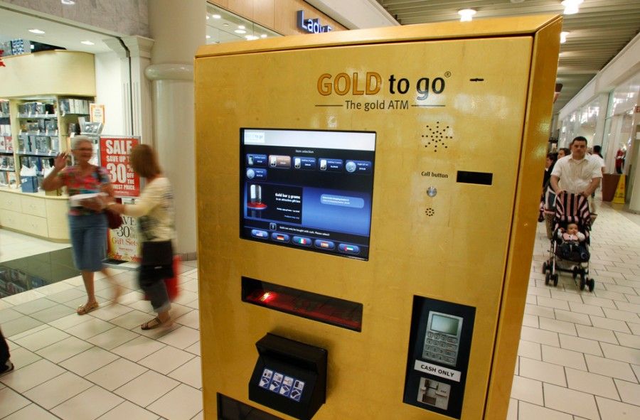 A gold-dispensing ATM machine is seen on its first day of operation at the Town Center Mall in Boca Raton, Florida December 17, 2010. The Gold to Go gold bullion vending machine was brought to the United States by PMX Gold LLC. REUTERS/Joe Skipper (UNITED STATES - Tags: BUSINESS)