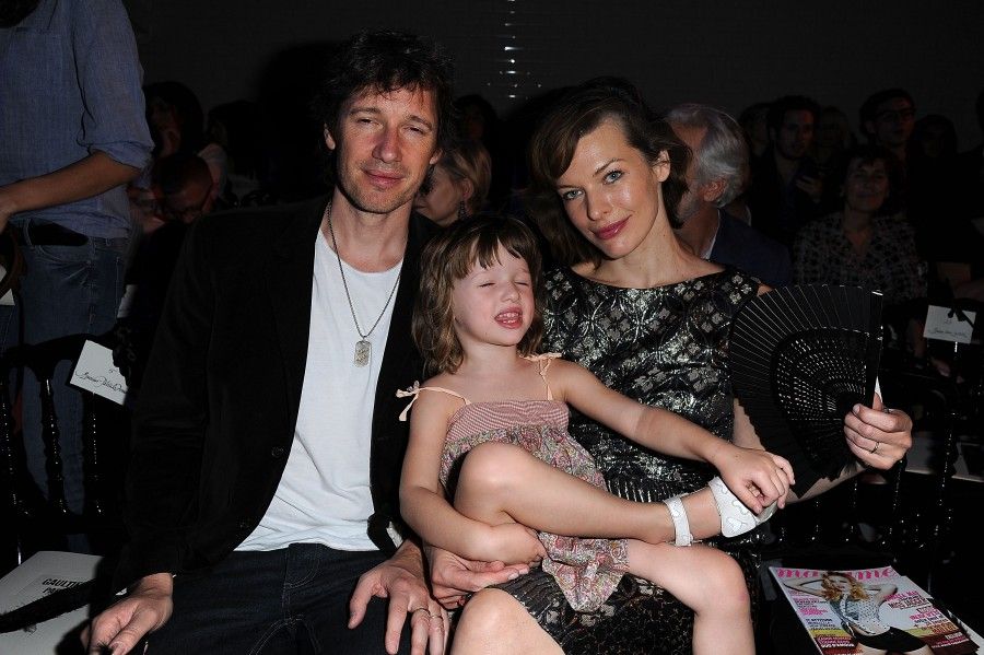 PARIS, FRANCE - JULY 06: Milla Jovovich (R), her husband Paul WS Anderson (L) and their daughter Ever Gabo attend the Jean Paul Gaultier Haute Couture Fall/Winter 2011/2012 show as part of Paris Fashion Week on July 6, 2011 in Paris, France. (Photo by Dominique Charriau/WireImage)