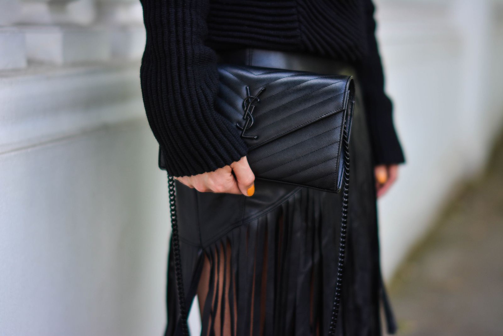 EJSTYLE-Emma-Hill-wears-River-Island-faux-leather-fringe-tassel-skirt-Romwe-black-jumper-YSL-quilted-envelope-clutch-bag-all-black-outfit