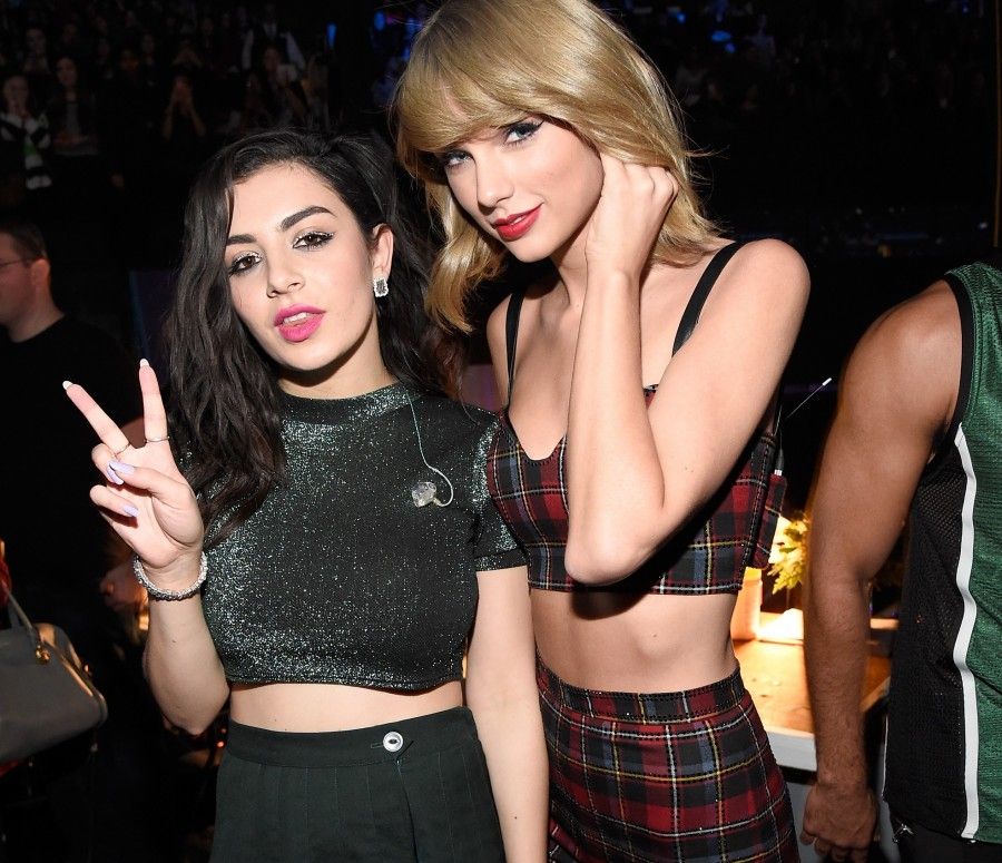 NEW YORK, NY - DECEMBER 12: Charli XCX (L) and Taylor Swift pose backstage at iHeartRadio Jingle Ball 2014, hosted by Z100 New York and presented by Goldfish Puffs at Madison Square Garden on December 12, 2014 in New York City. (Photo by Kevin Mazur/WireImage)