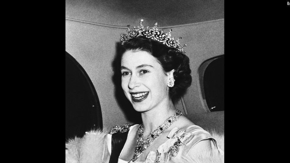 Princess Elizabeth smiles broadly as she arrives at the French Embassy in London's Kensington Palace Gardens, on Mar. 8, 1950 to attend a state banquet tendered by French President and Madame Vincent Auriol. (AP Photo)