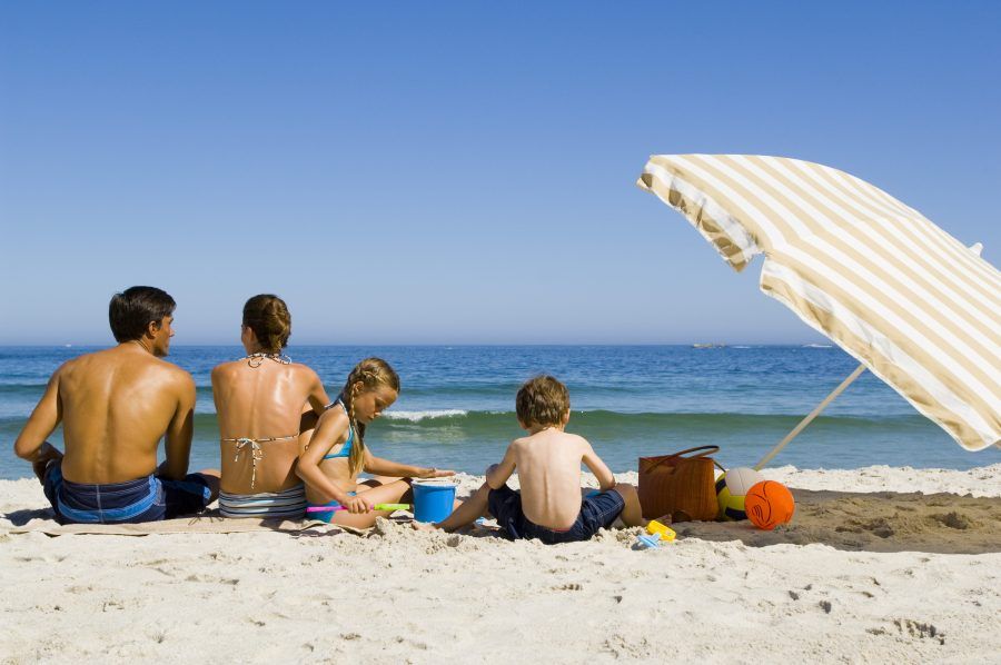 Family relaxing at beach together