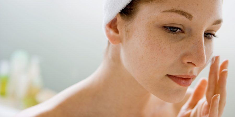 Woman using moisturizing cream