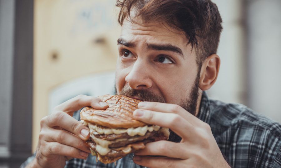 Main-Eating with Hands-man eating burger-shutterstock_343493552
