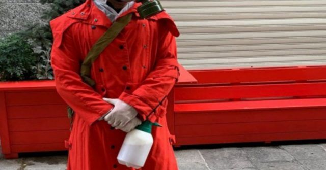 Uomo mantello rosso e maschera anti gas