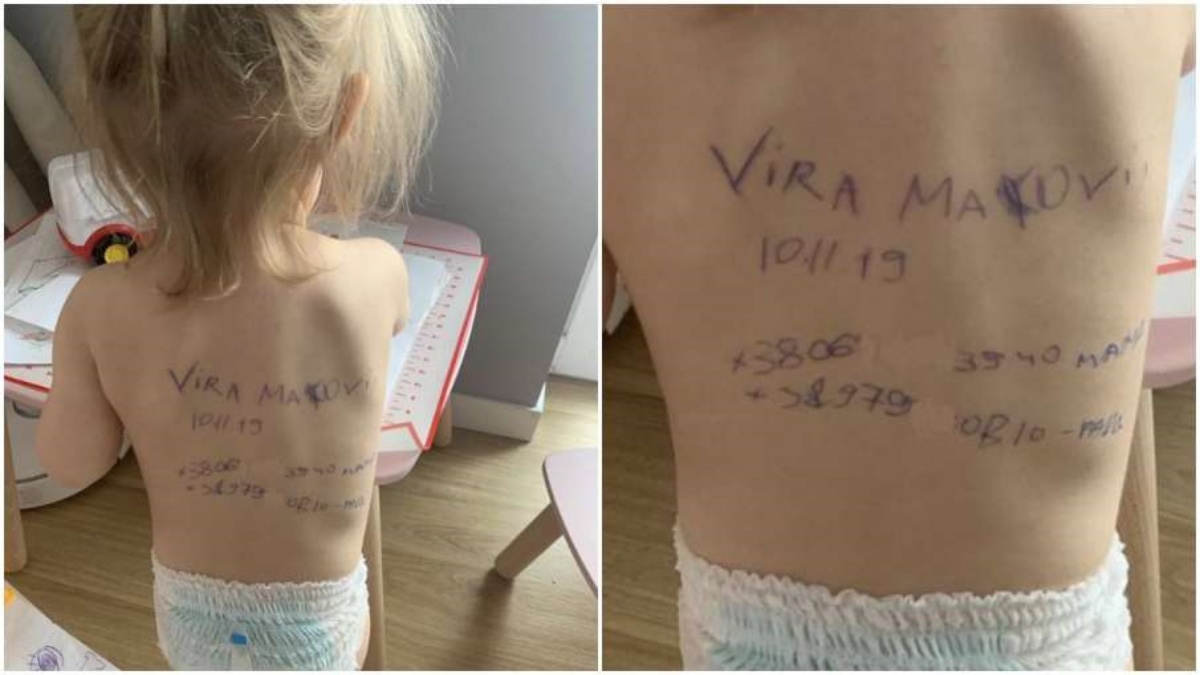 Vira la bambina con la scritta sulla schiena