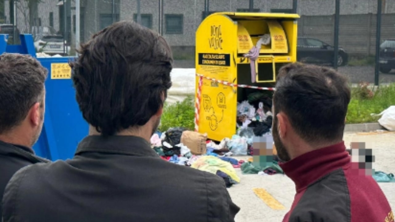 Romeo Antoine gets stuck in the used clothes bin